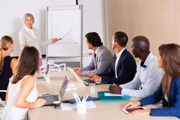 istock Woman reading out report to colleagues 1244932832
