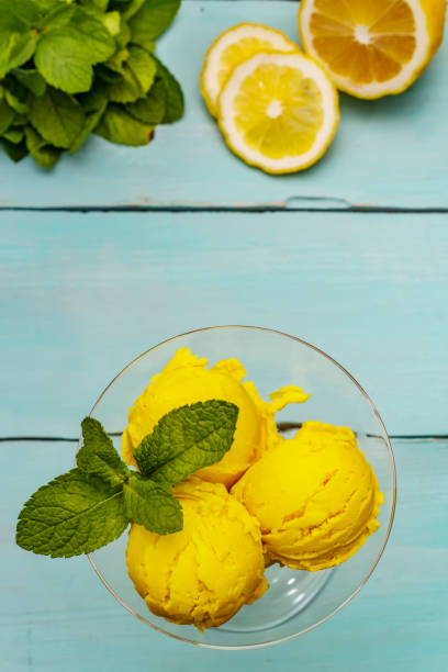 istock Lemon ice cream with mint. Refreshing summer dessert, ripe fruit, fragrant leaves 1244935344