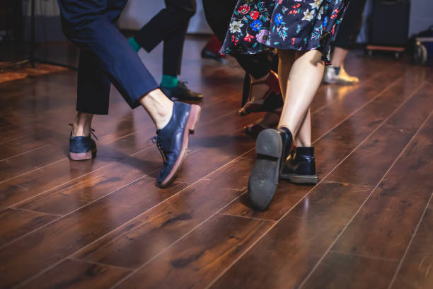 dancing shoes of young couple dance retro jazz swing dances on a ballroom club wooden floor, close up view of shoes, female and male, dance lessons - polka dancing imagens e fotografias de stock