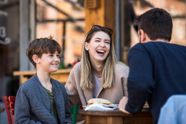 istock Father, son and mother eating food and drinking inside a restaurant 1244936514