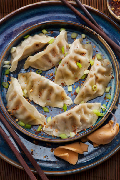 Steamed Dumplings with Soy Sauce and Green Onions Steamed Dumplings with Soy Sauce and Green Onions chinese dumpling stock pictures, royalty-free photos & images