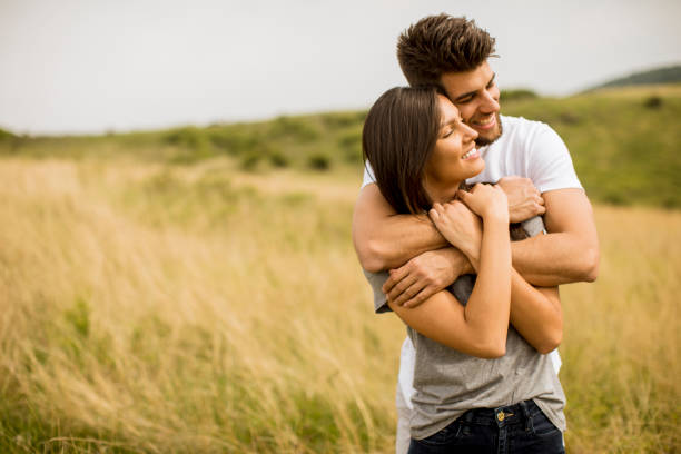 istock Young couple in love outside in spring nature 1244941665