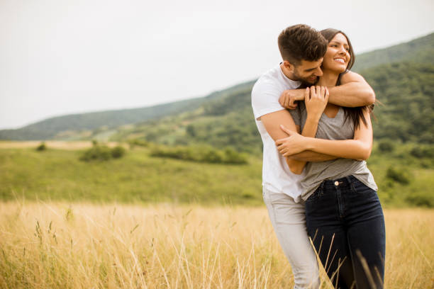 istock Young couple in love outside in spring nature 1244941667
