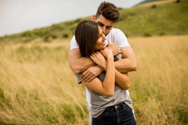 istock Young couple in love outside in spring nature 1244941679