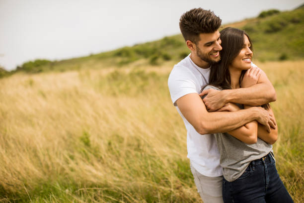 istock Young couple in love outside in spring nature 1244941686