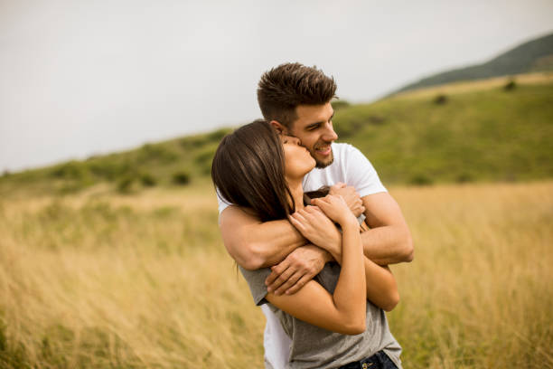 istock Young couple in love outside in spring nature 1244941687