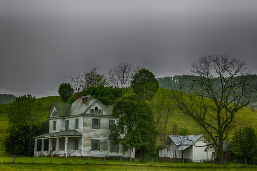 Salem, Virginia, USA -  May 22, 2020:  A beautiful weathered farm house attracts the eye in rural Virginia countryside