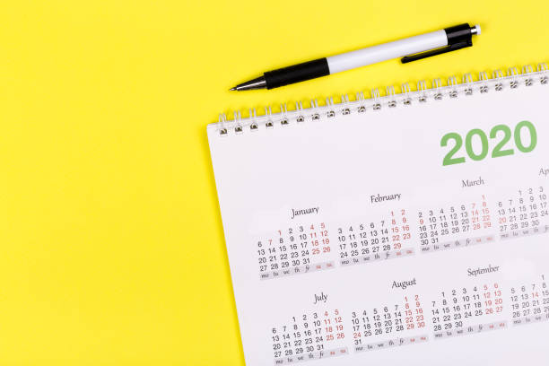 istock White clean calendar 2020  on solid yellow background with copy space, business meeting schedule, travel planning or project milestone and reminder concept. 1244965546