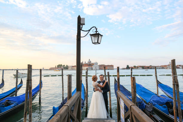 istock beautiful wedding couple posing near dock 1244969294