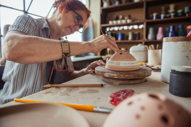 istock Woman decorating bowl made of clay 1244977657
