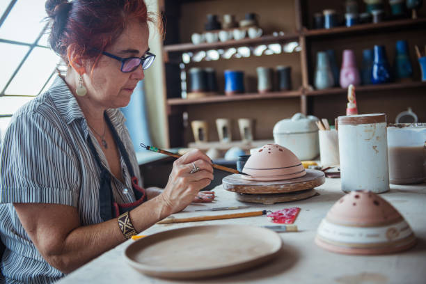 istock Woman decorating bowl made of clay 1244977669