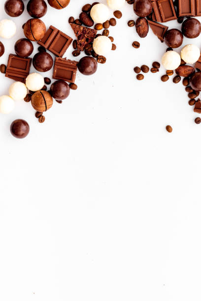 istock Chocolate background on white table top-down frame. Sweet desserts concept. Copy space 1244982041