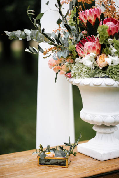 istock Table with wedding rings at wedding ceremony outdoors in the garden. 1245001607
