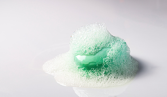 Soap bar with bubble on white background