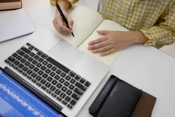 istock E-learning Education Internet Networking . Young businesswoman sitting at table used laptop with inscription on screen e-learning. Online education e-learning. 1245002741