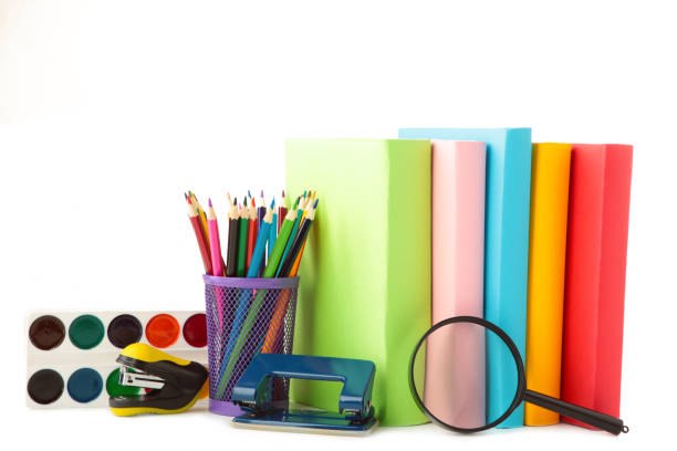Multi coloured school books and stationery isolated on white background. Copy space. Back to school