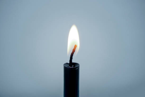 istock Closeup of Candlelight burning stick black on blue background With copy space 1245008703