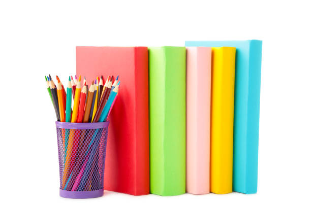 istock Multi coloured school books and pencils isolated on white background 1245009230