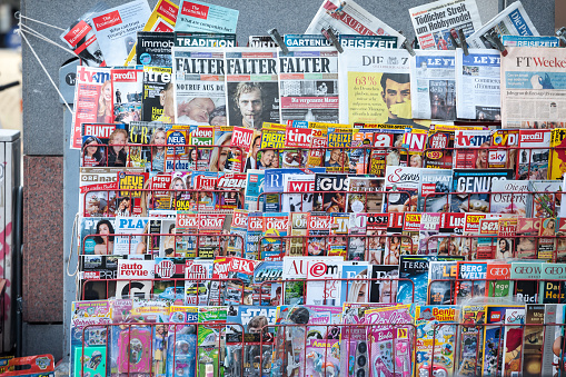 Koblenz, Germany - August 7th 2023: Women's magazines and TV guide magazines on public newsstand shell