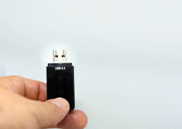 istock human male hand holding a USB flash memory on a white background. 1245024532