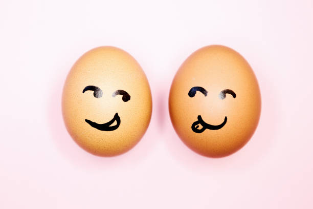 istock Two eggs with cartoon faces seem attracted to each other 1245026129
