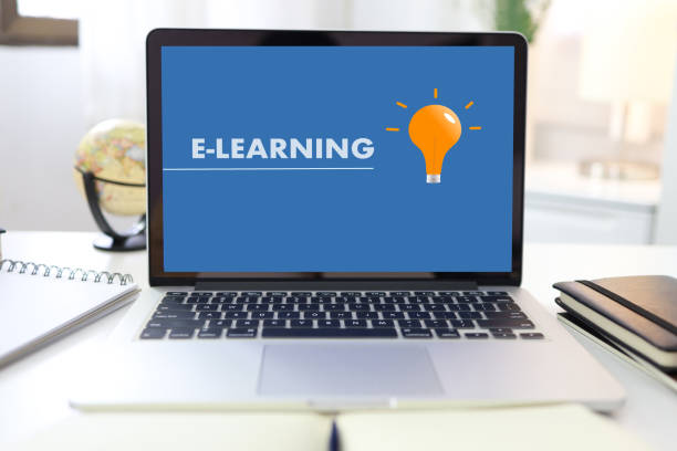 istock E-learning Education Internet Networking . Young businesswoman sitting at table used laptop with inscription on screen e-learning. Online education e-learning. 1245026699