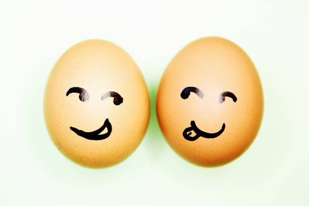 istock Two eggs with cartoon faces seem attracted to each other 1245029462