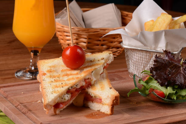 toast served with tomatoes and orange juice