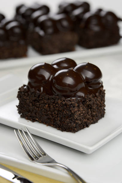 istock chocolate cake with white cream in the dish on the table 1245029502