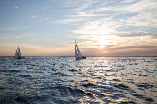 istock Two sailboats at sunset 1245030019
