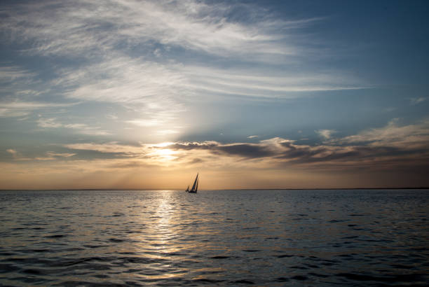 istock Two sailboats at sunset 1245030039