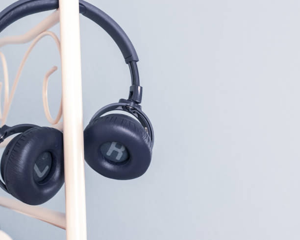 istock Blue wireless headphones on stand with copy space. 1245039513