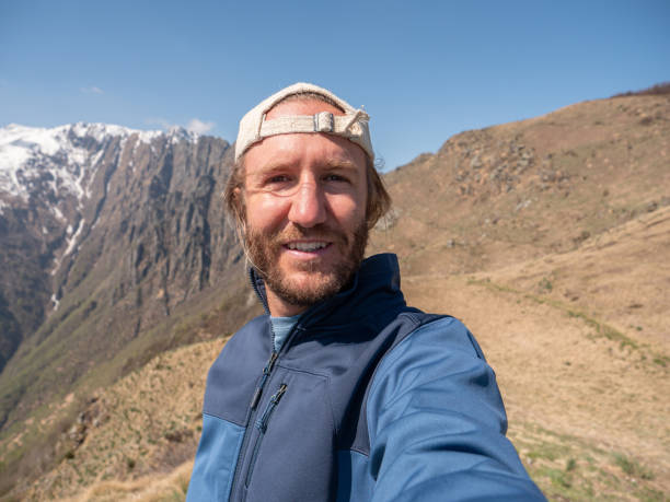 istock Cheerful young man taking a selfie portrait on mountain top 1245041359