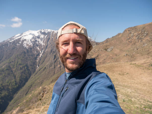 istock Cheerful young man taking a selfie portrait on mountain top 1245041389