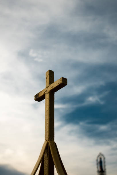 croix d’or sur le dessus de l’église dans le ciel bleu - the crucifixion audio photos et images de collection