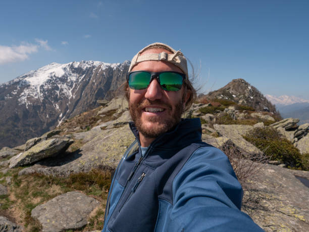 istock Cheerful young man taking a selfie portrait on mountain top 1245041547