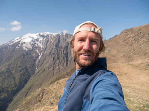 istock Cheerful young man taking a selfie portrait on mountain top 1245041708