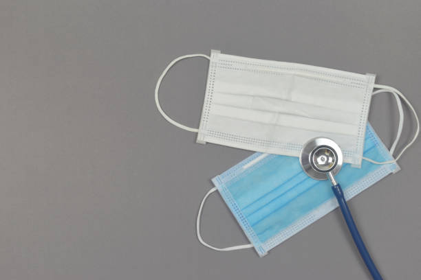 istock Stethoscope with medical mask on blue background. 1245041712