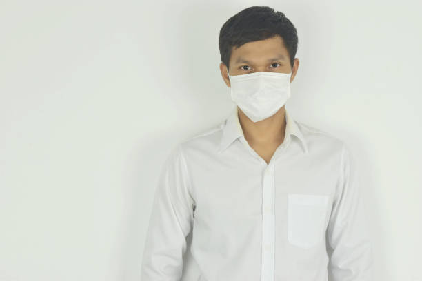 istock man wearing a medical mask on white background. 1245041778