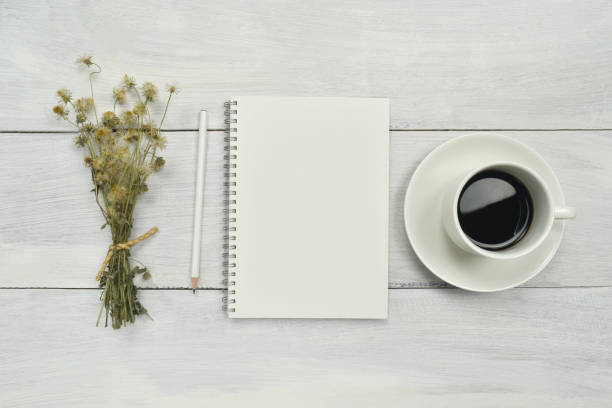 istock Blank paper notebook with coffee and dried flower on the side. 1245042137