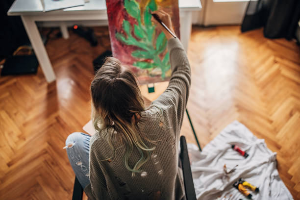 istock Young female painter painting at home 1245043266