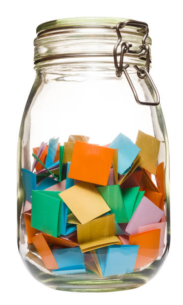 istock Multicolored paper notes canned in glass jar. 1245045623