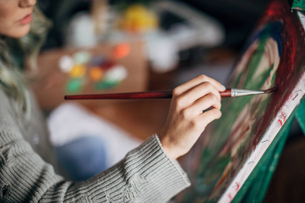 artista femenina pintando en la sala de estar - oil painting painted image art studio fun fotografías e imágenes de stock