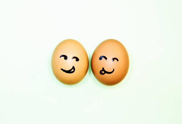 istock Two eggs with cartoon faces seem attracted to each other 1245050498