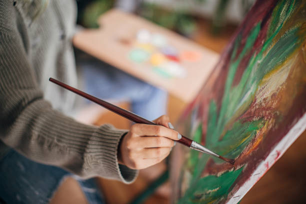 istock Female artist painting 1245050582