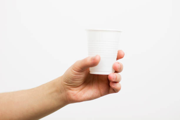 istock female male hand holding a white plastic cup isolated 1245072142