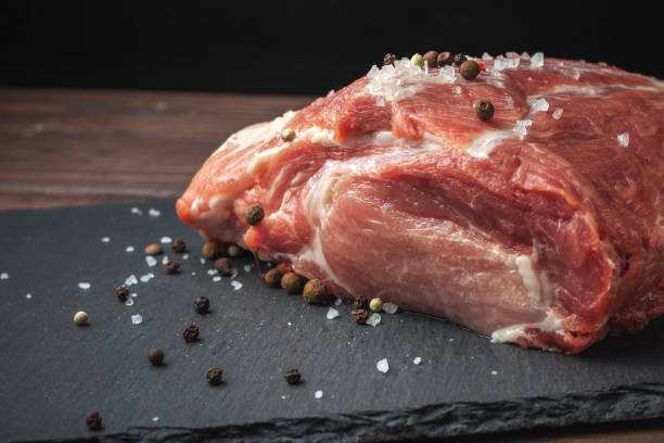istock Raw pork chop steak on a black board. Pork antricot 1245074535