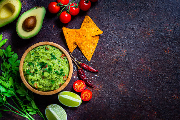 istock Guacamole and chips shot from above on dark brown table. Copy space 1245074975