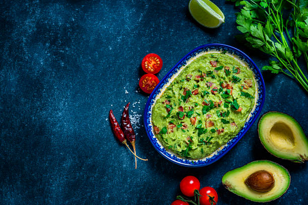 istock Guacamole and chips on bluish tint table. Copy space 1245075066