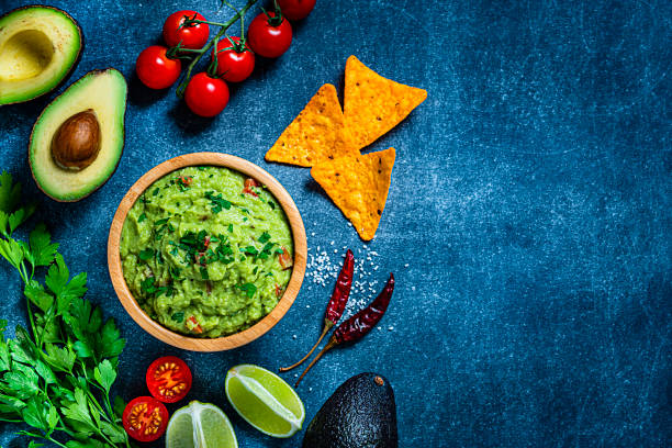 istock Guacamole and chips on bluish tint table. Copy space 1245075081